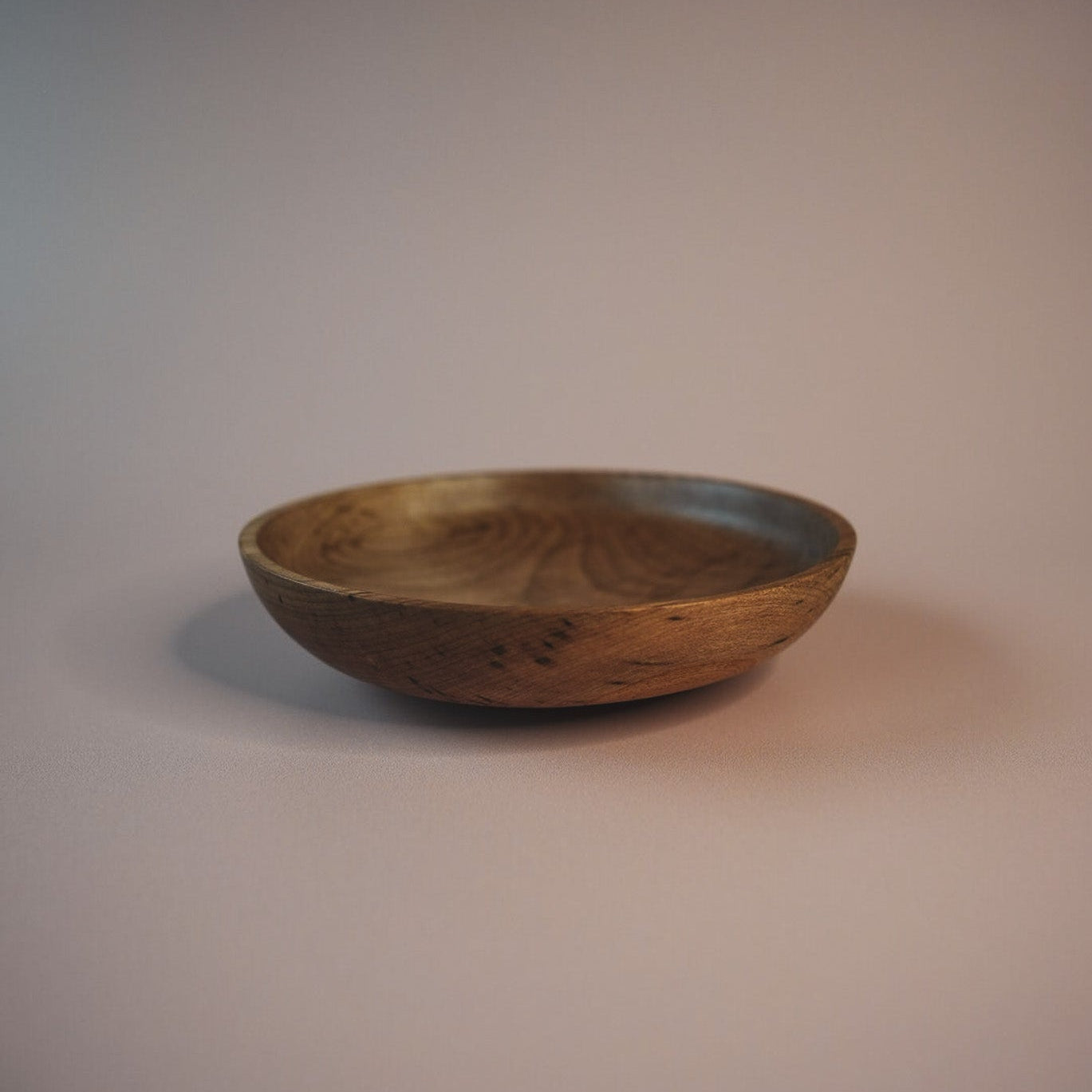 sweet chestnut wooden bowl on a gradient background