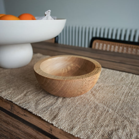 Chunky sycamore wooden bowl on dark oak table with hessian runner