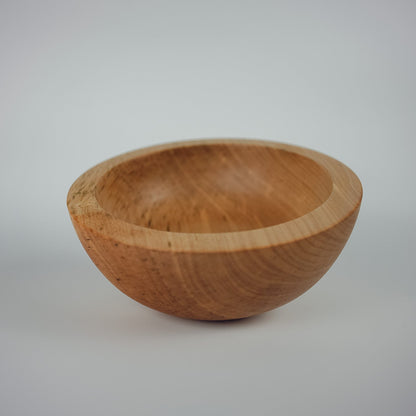 side angle of a chunky medium sized fruit bowl made from sycamore wood