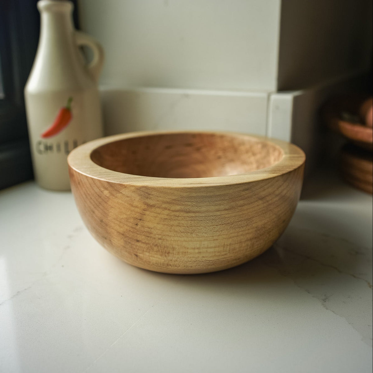 Chunky yet medium sized wooden bowl in a kitchen setting