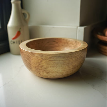 Chunky yet medium sized wooden bowl in a kitchen setting