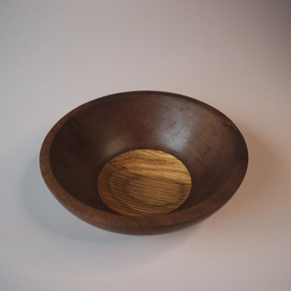 Wooden bowl with a contrasting inner surface make with oak on a plain background