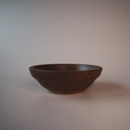 dark apple wood bowl on an plain background
