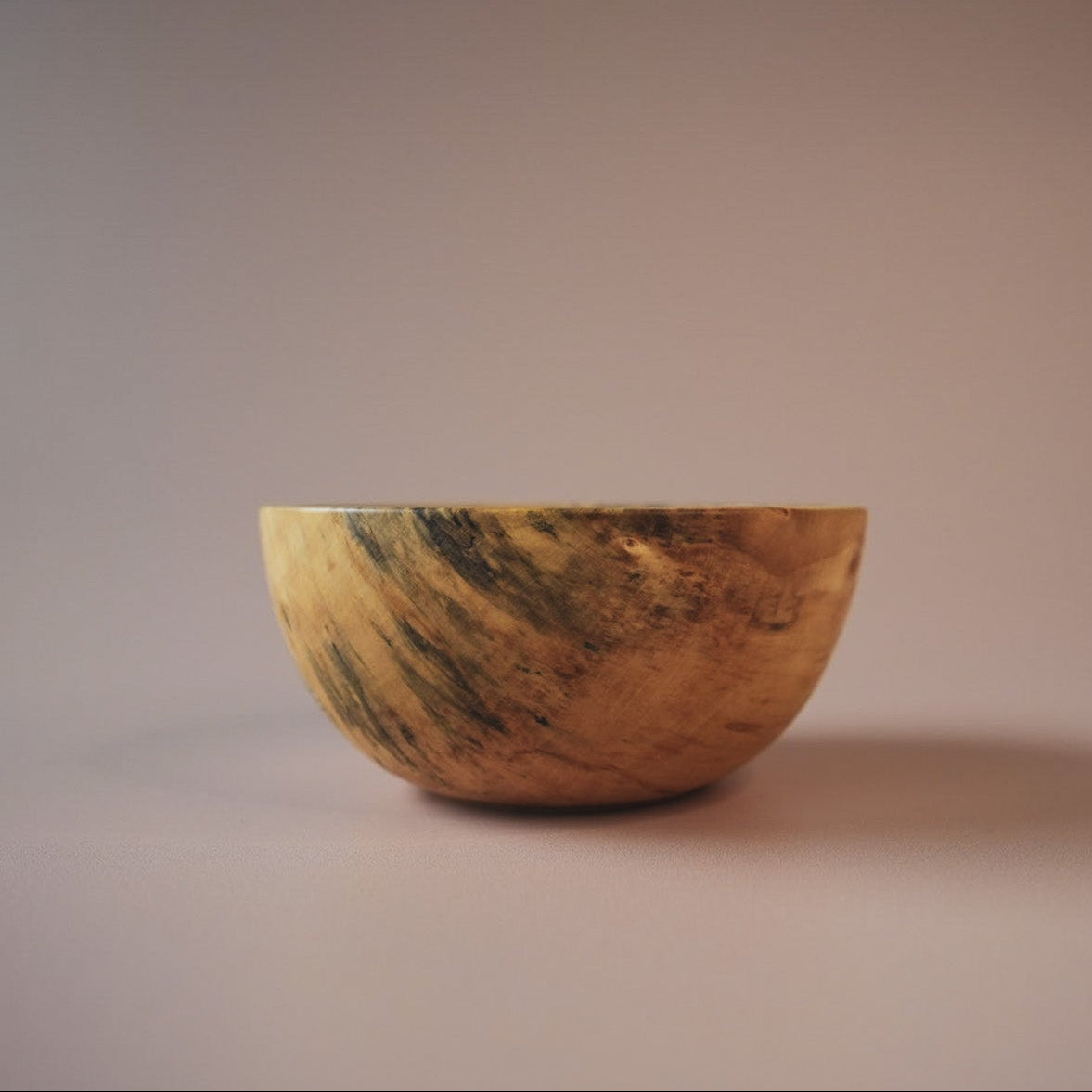 small spalted sycamore bowl on pink background