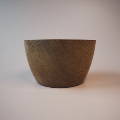 Wooden bowl on a plain background