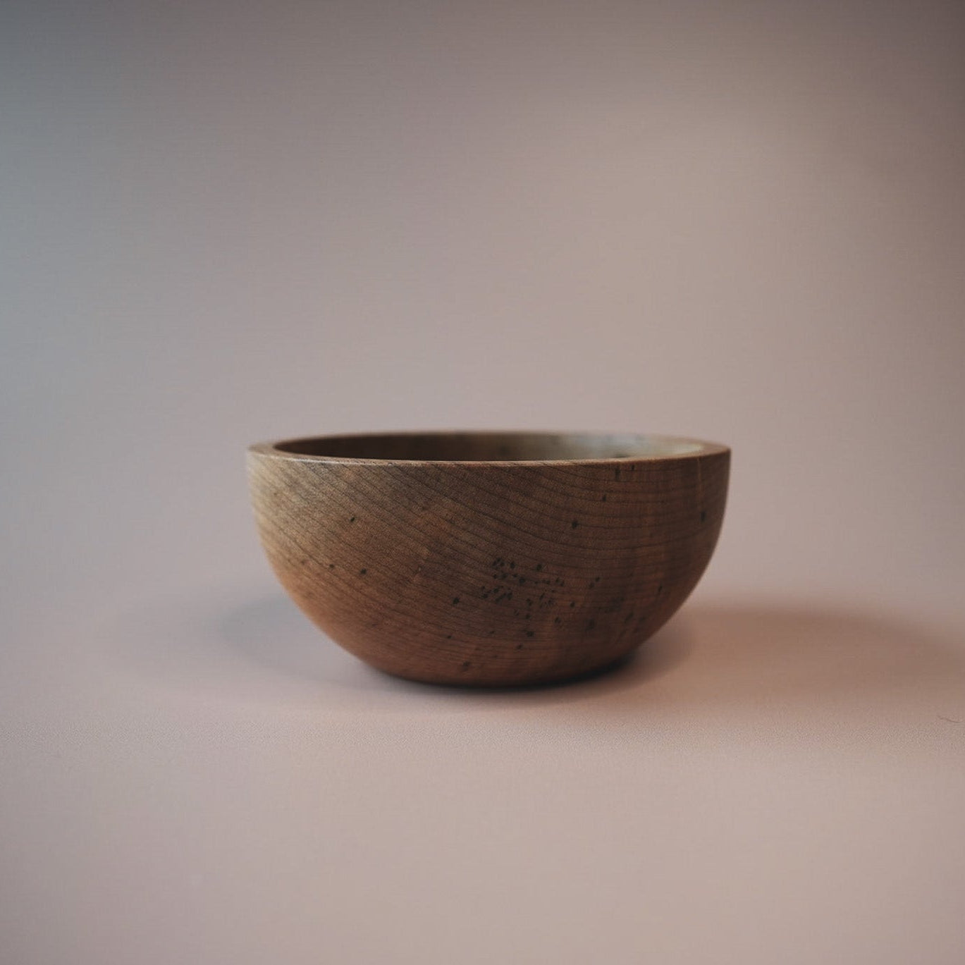 Sweet chestnut wood bowl on a pink background